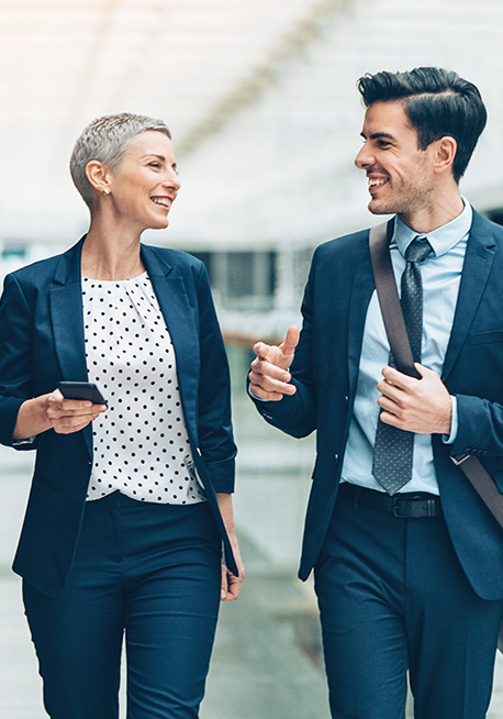 Man and woman walking down office hall